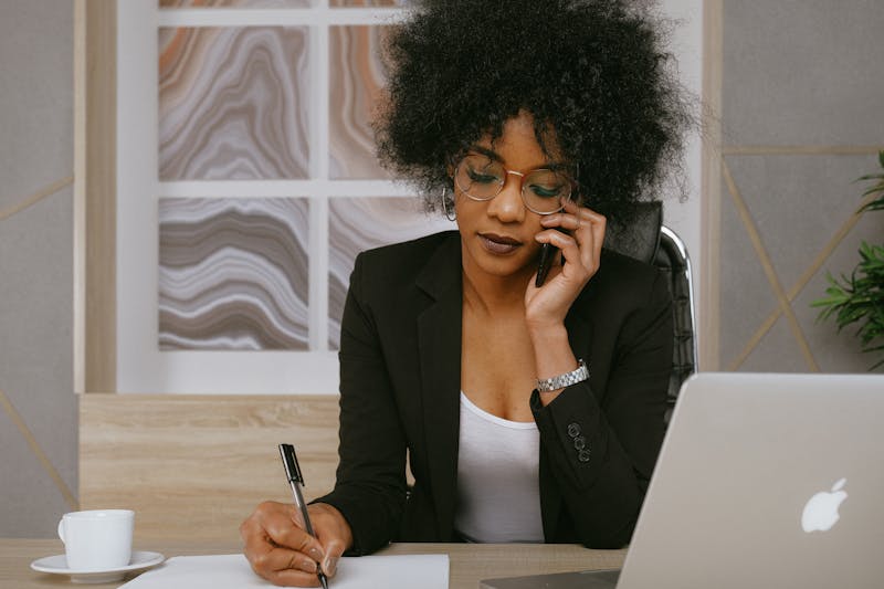 Business professional making a call on a smartphone at their desk